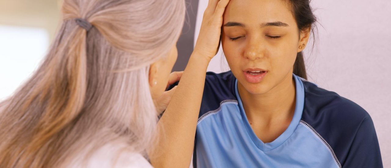 A concussed soccer player seeks help at the doctors office